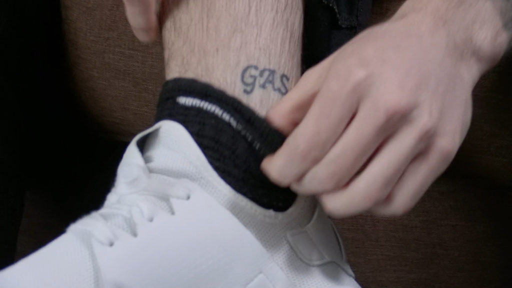 "gas" tattooed on an ankle