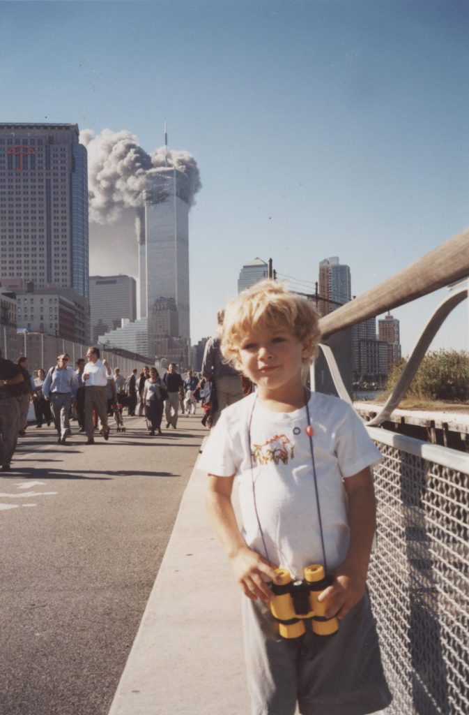 boy in front of burning World Trade Center