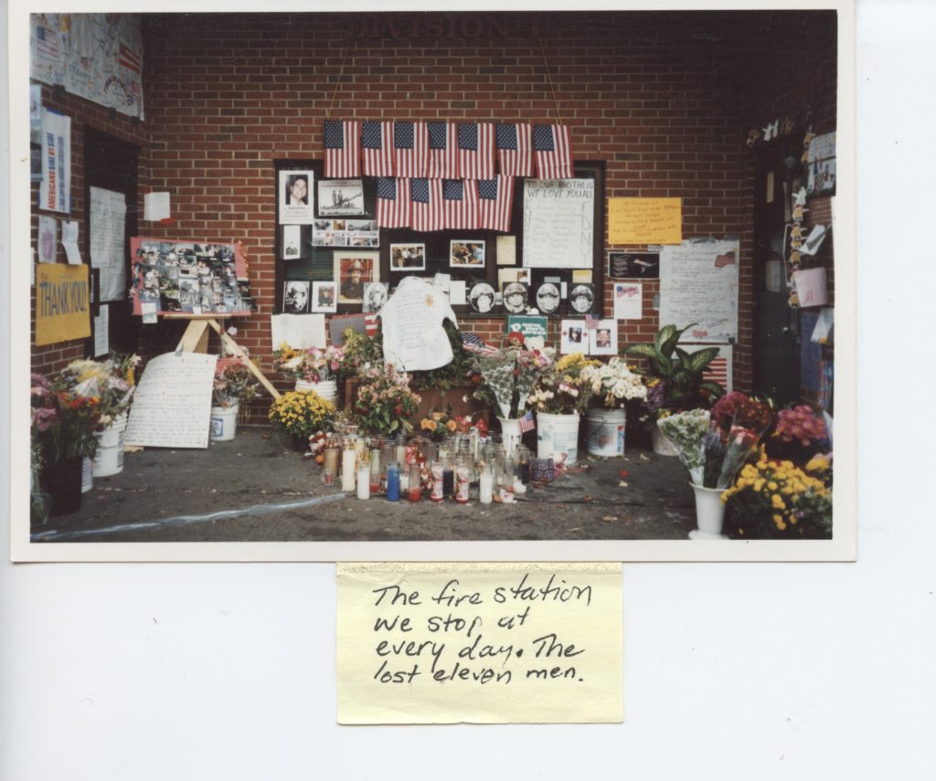 Fire station memorial with flags and photos.