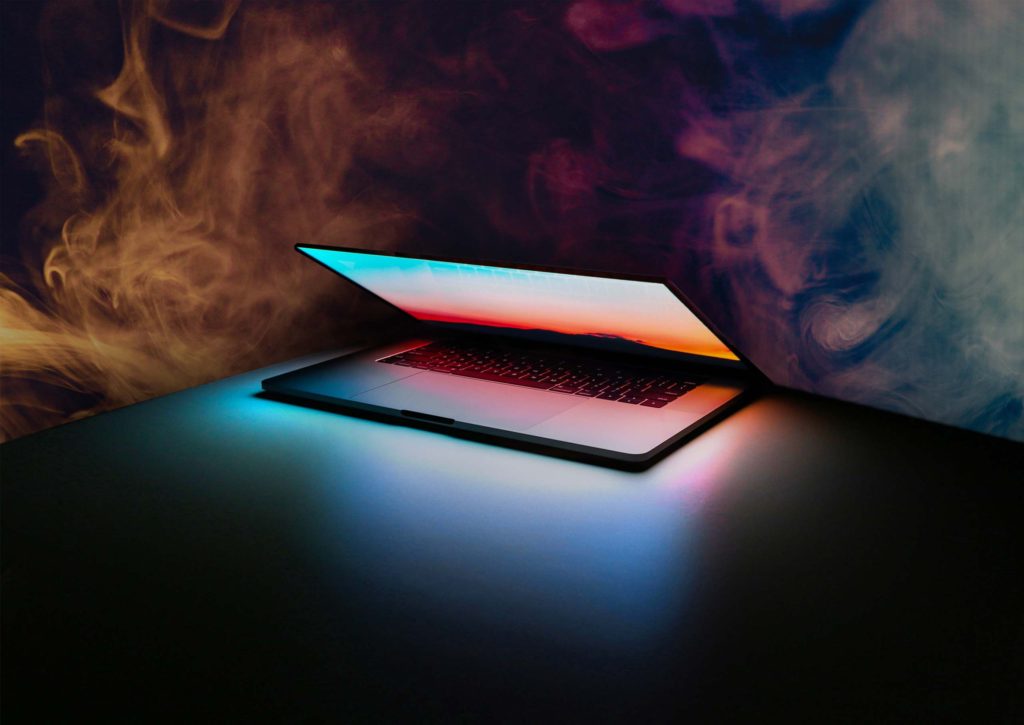 A MacBook surrounded by fumes