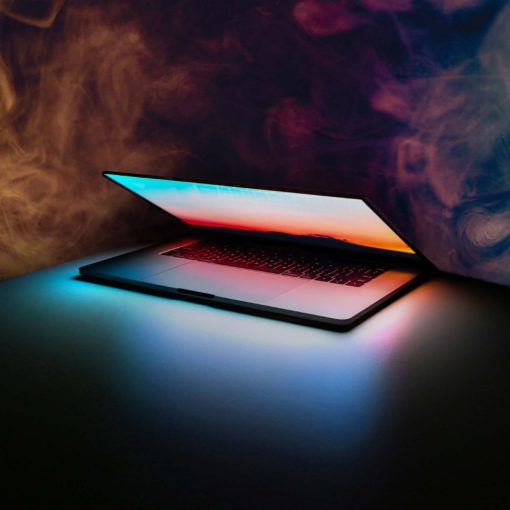 A MacBook surrounded by fumes